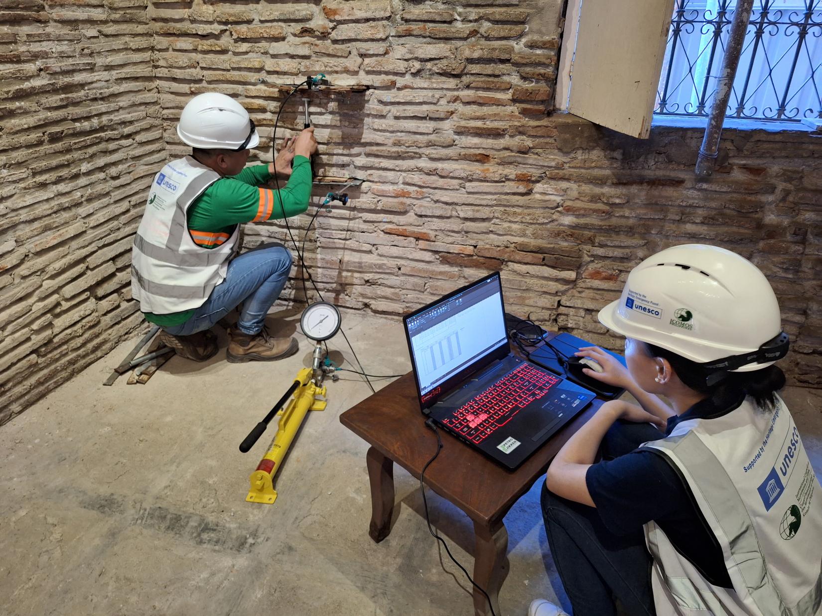 Technicians assess the structure of an historic building in Vigan.