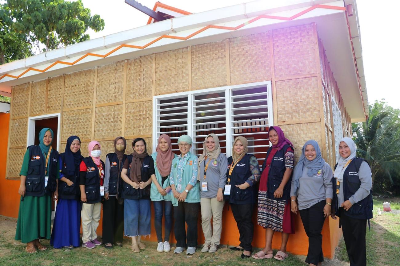 Community facilitators pose in front of the Women-Friendly Space (WFS) in Guindulungan, Maguindanao del Sur.