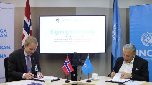 The Norwegian Ambassador to the Philippines and UN Philippines Resident Coordinator sit adjacent to each other, signing documents.